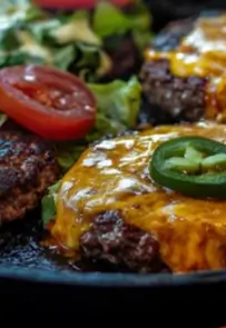  Smash burger patties with melted cheddar cheese and jalapeño slices, served with fresh tomato and lettuce.