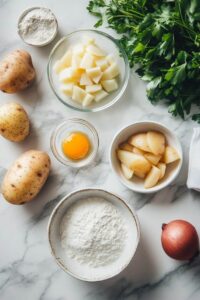 ngredients for German Potato Pancakes arranged on a marble countertop, including raw potatoes, diced cooked potatoes, parsley, an egg yolk, flour, and an onion.