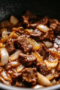 Tender chunks of beef simmered with caramelized onions in a rich, savory broth, the flavorful base for French Onion Beef and Noodles.